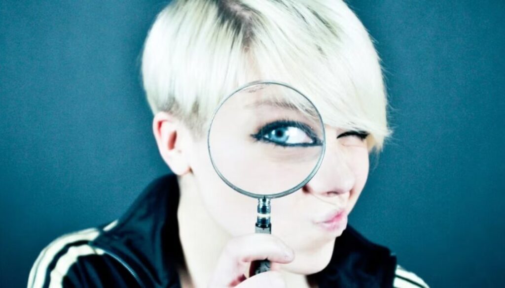 woman-looking-through-magnifying-glass