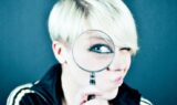 woman-looking-through-magnifying-glass